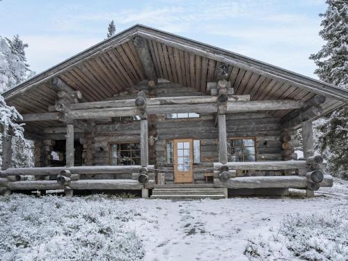 a log cabin in the snow at Holiday Home Kantolan veska by Interhome in Ruka
