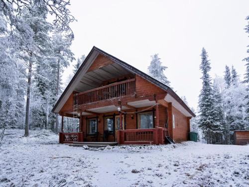 a log cabin in the woods in the snow at Holiday Home Hillakumpu by Interhome in Nissi