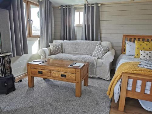 a living room with a couch and a coffee table at The Cwtch Knighton Powys Hot Tub included in Knighton