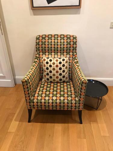a polka dot chair sitting in a room at Via Napoli Apartments in Rome