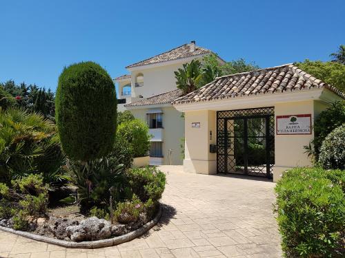 a building with a gate in a garden at Vista Hermosa Marbella in Marbella