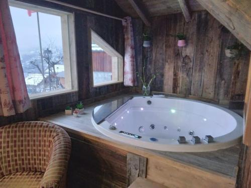 a large bath tub in a room with a window at Chalet La Plagne jacuzzi vue top in Montchavin