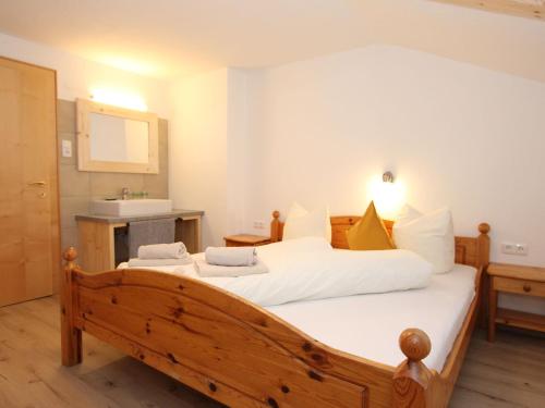 a bedroom with a large bed and a sink at Holiday Home Sonnblick by Interhome in Uderns