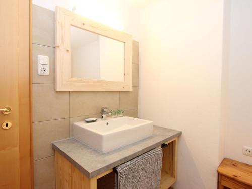 a bathroom with a white sink and a mirror at Holiday Home Sonnblick by Interhome in Uderns