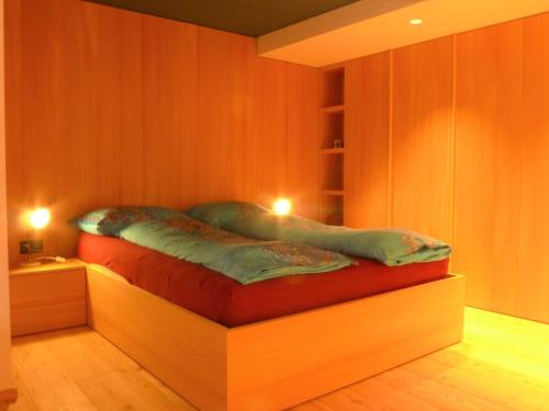 a bed in a room with two lights on it at Apartment Armina by Interhome in Zermatt