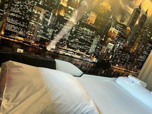 a bedroom with a view of a city skyline at NEW - Bat'Appart - DIJON - Insolite in Longvic