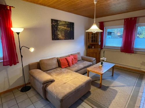 a living room with a couch and a table at Holiday Home Ferienpark Himmelberg-8 by Interhome in Thalfang