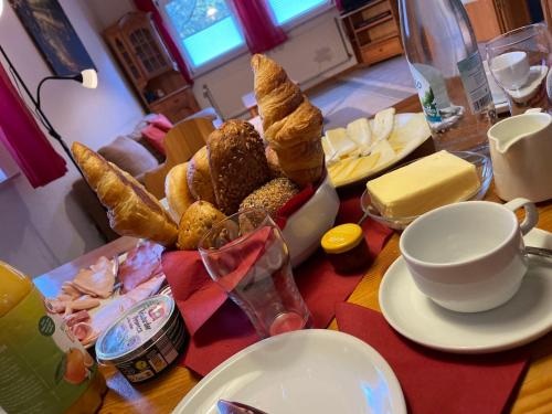 a table with a bunch of bread and a cup of coffee at Holiday Home Ferienpark Himmelberg-8 by Interhome in Thalfang