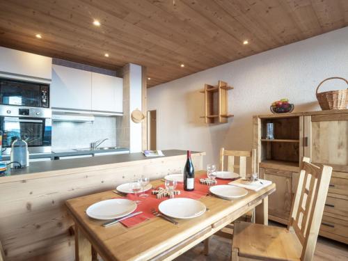 a kitchen with a wooden table with a bottle of wine at Apartment Les Genepis-5 by Interhome in Tignes