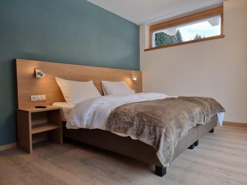 a bedroom with a large bed and a window at Apartment Alpenschnucke Home by Interhome in See