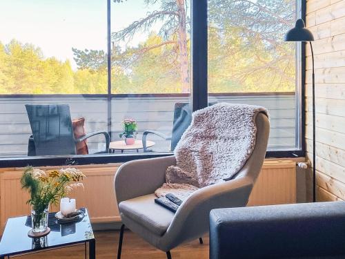 a chair sitting in a room with a window at Holiday Home The cozy loggers suite by Interhome in Salla