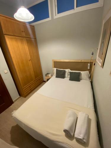 a bedroom with a large white bed with two pillows at Center Madrid habitaciones in Madrid