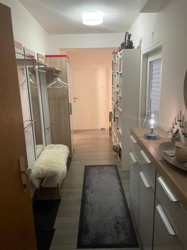 a room with a kitchen with a counter and a room with a refrigerator at Grenzberg Top 20 in Bad Gastein