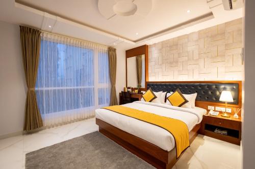 a bedroom with a large bed and a window at La Serene Boutique Hotel - Manyata Tech Park in Bangalore