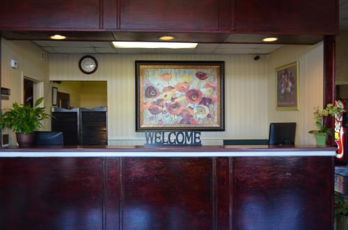 a lobby with a reception counter with a painting on the wall at Travel Inn in Birmingham