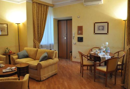 a living room with a couch and a table at Dea Suite Roma in Rome