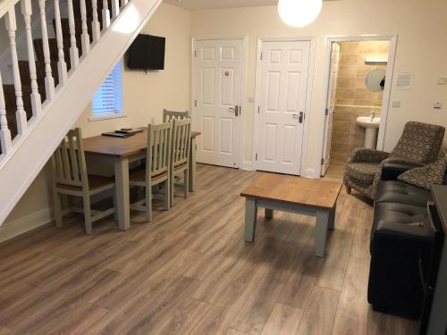 a living room with a table and a dining room at Beach Haven Apartments in Tramore