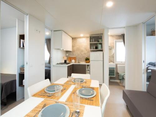 a kitchen and living room with a table and chairs at Holiday Home Bella Italia-7 by Interhome in Peschiera del Garda