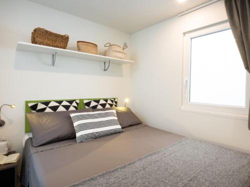 a small bedroom with a bed and a window at Holiday Home Bella Italia-7 by Interhome in Peschiera del Garda