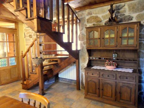 a wooden staircase in a room with a table at Casa da Laxa in Beáriz