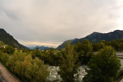 a river with trees and mountains in the background at BnB Haus Weibel in Landquart
