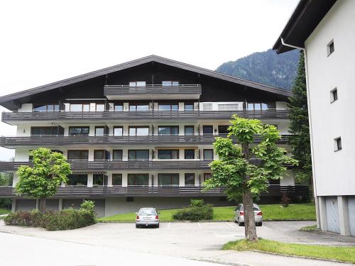 a large building with cars parked in front of it at Apartment Hasennest by Interhome in Bad Hofgastein