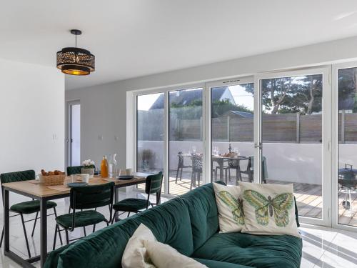 un salon avec un canapé vert et une table dans l'établissement Holiday Home La cinquième Saison by Interhome, à Plouescat