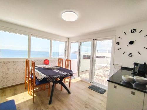 a kitchen with a table and a clock on the wall at Apartment Suecia by Interhome in Benidorm