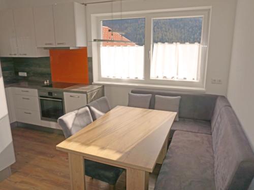 a kitchen with a table and a couch in a kitchen at Apartment FeWo Anna by Interhome in Alterzoll