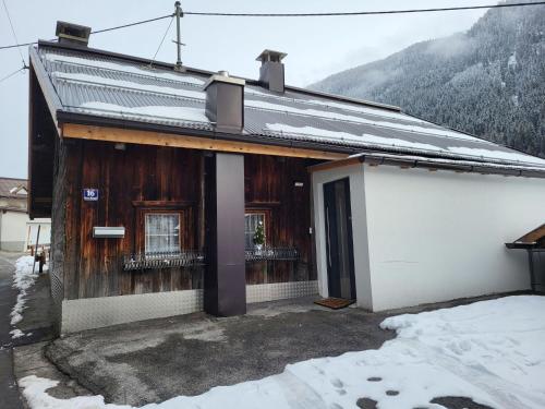 a house with snow on the ground in front of it at Holiday Home Stark by Interhome in Kappl