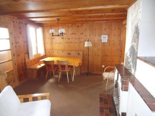 uma sala de jantar com uma mesa e cadeiras num camarote em Chalet Chalet Pitschun by Interhome em Grindelwald
