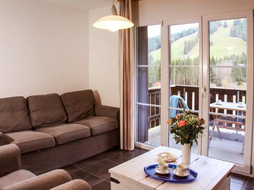 a living room with a couch and a table at Apartment Andromède 6 by Interhome in Moleson
