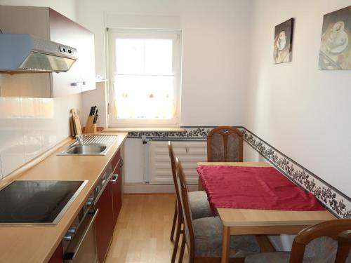 a kitchen with a table and a sink and a window at Apartment Nordlicht by Interhome in Bremerhaven