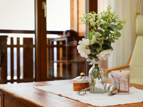a vase filled with flowers sitting on a table at Apartment Grand Hôtel B47 by Interhome in Villars-sur-Ollon