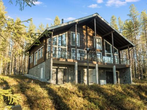 a house on top of a hill with trees at Holiday Home Herrasmäki by Interhome in Sirkka