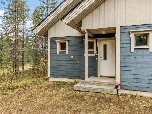 a blue house with a white door and a porch at Holiday Home Hopeatalo b by Interhome in Pyhätunturi