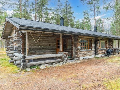 a log cabin with a black roof at Holiday Home Kuopiokero by Interhome in Pyhätunturi