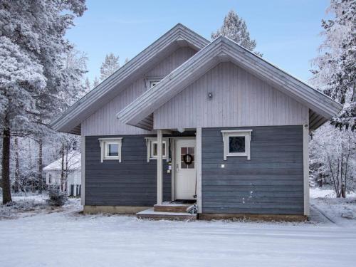 a small house with a door in the snow at Holiday Home Aslakin helmi a by Interhome in Pyhätunturi