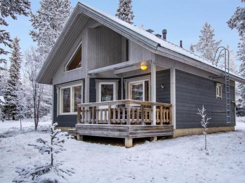 a small house with a deck in the snow at Holiday Home Aslakin helmi a by Interhome in Pyhätunturi