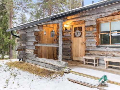 a log cabin with a front door in the snow at Holiday Home Luppokero 3 by Interhome in Pyhätunturi
