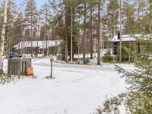 a snow covered road in front of a cabin at Holiday Home Luppokero 3 by Interhome in Pyhätunturi
