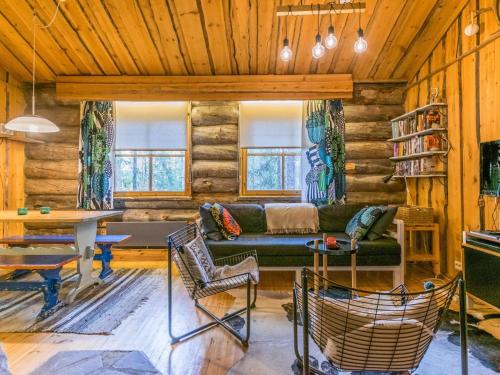 a living room with a couch and a table at Holiday Home Luppokero 2 by Interhome in Pyhätunturi