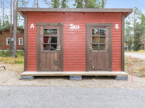 a small red shed with two doors at Holiday Home Antura b by Interhome in Pyhätunturi