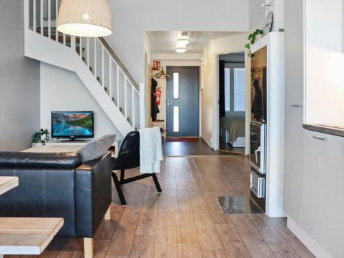 a living room with a couch and a staircase at Holiday Home Skivillas 78 - 4 by Interhome in Hyrynsalmi