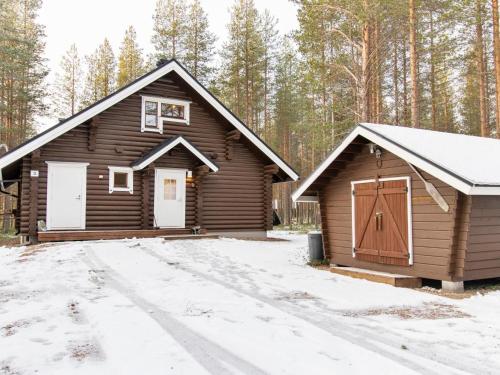 a cabin in the woods with snow on the ground at Holiday Home Kirnutie 3 by Interhome in Pyhätunturi