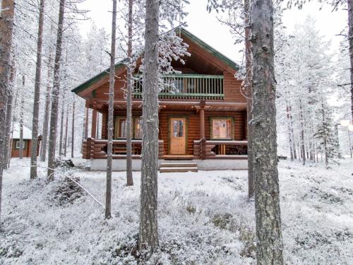 a log cabin in the woods in the snow at Holiday Home Petsankolo by Interhome in Pyhätunturi