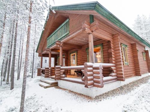 a log cabin in the woods in the snow at Holiday Home Petsankolo by Interhome in Pyhätunturi