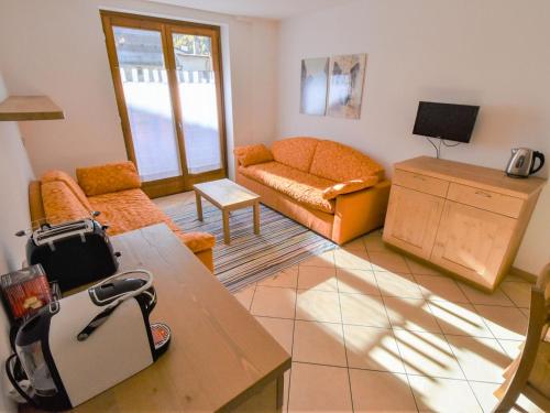 a living room with a couch and a table at Apartment Cà Serena by Interhome in Campodolcino