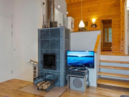 a living room with a fireplace and a tv at Holiday Home Sallan lumous b by Interhome in Salla