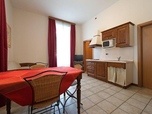 a kitchen with a table and a kitchen with a counter at Apartment Villa Nicole by Interhome in Arco